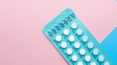 birth control packet on pink background