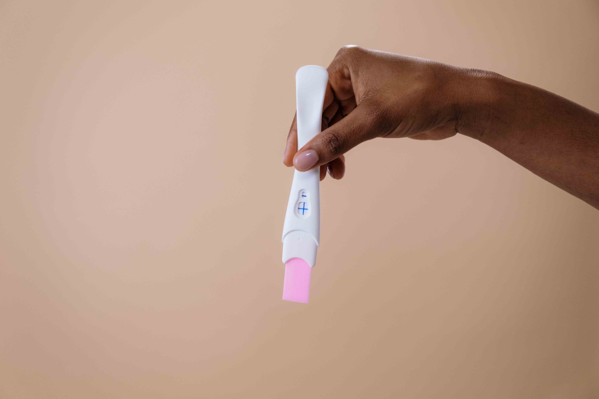 hand holding pregnancy test