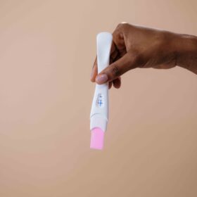 hand holding pregnancy test