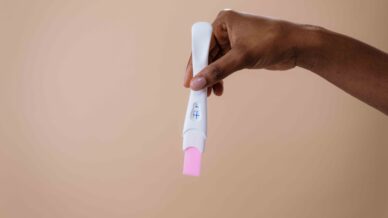 hand holding pregnancy test