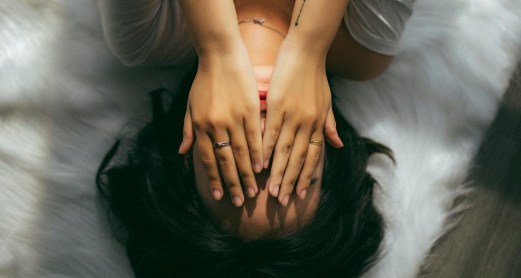 Woman covering her face