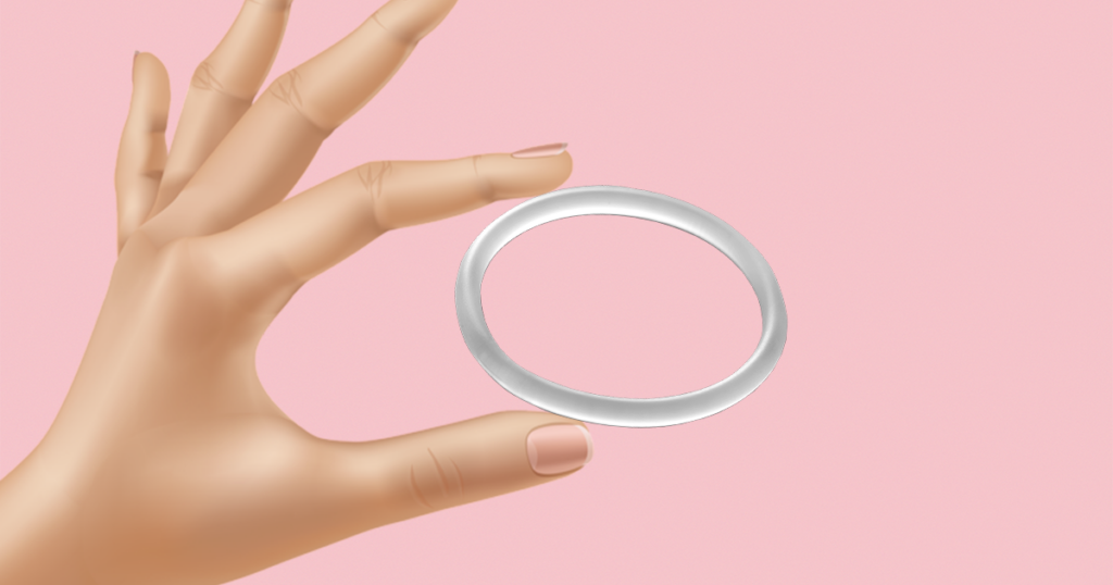 hand holding a vaginal ring in between thumb and finger