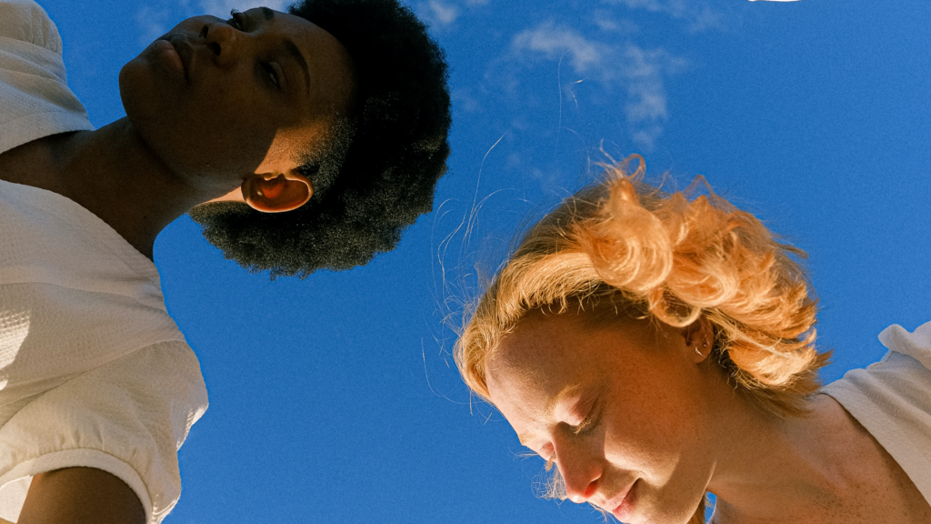 Two women in the sunshine against a blue sky