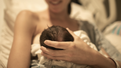 Woman breastfeeding newborn